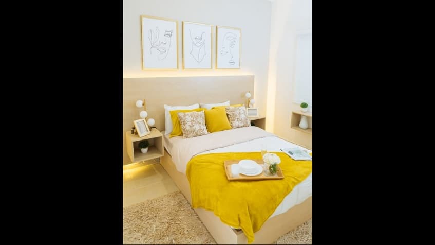 Bedroom with illuminated headboard at Portocristo Condos