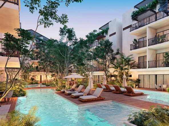 Two pools and solarium wooden deck in the middle, surrounded by white residential building at Costa Caribe