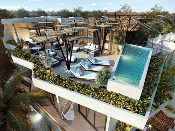 Rooftop view with a pool, solarium and lounge area at Rama Tulum
