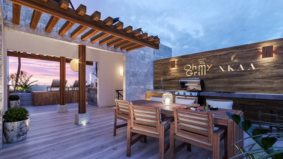 Rooftop bbq grill area with dining table at Xkaa Ocean View Condos