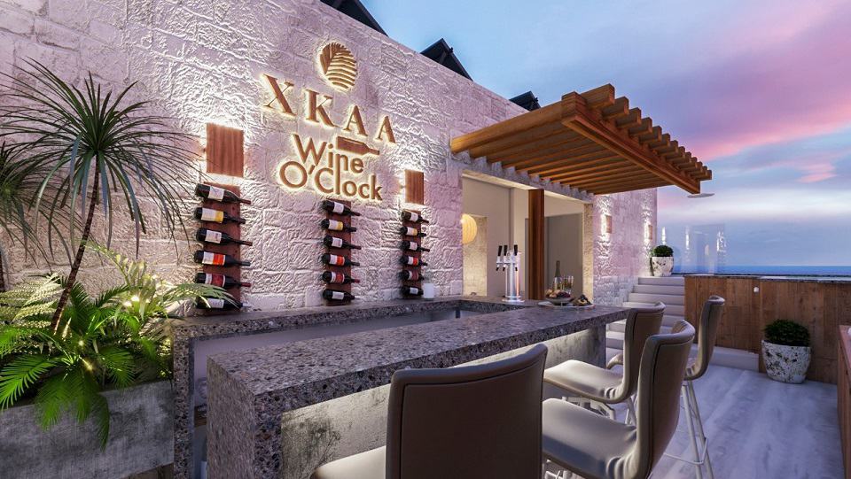 Rooftop bar with wine glasses decor and ocean in the background at Xkaa Ocean View Condos
