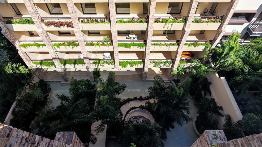 Top view of residential building with balconies and pool garden at Syrena Studio Living