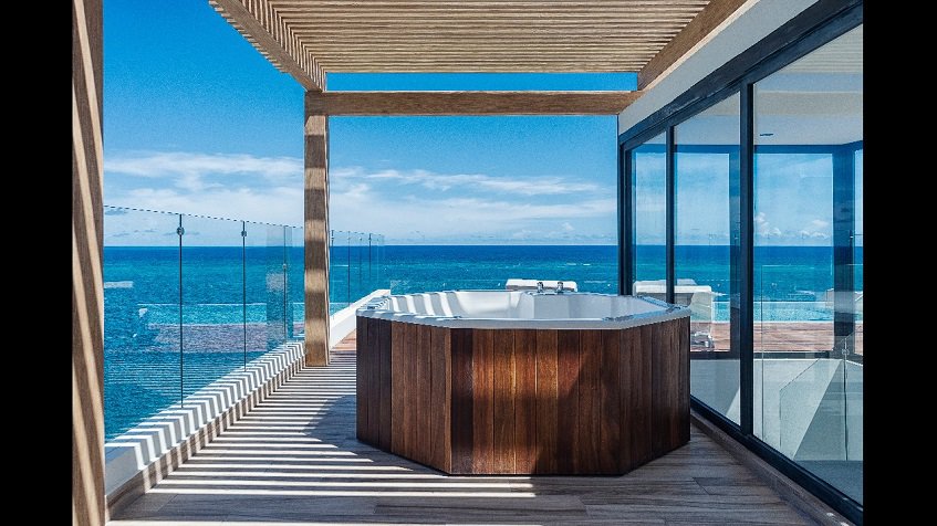 Terrace with a jacuzzi and ocean view at The Fives Oceanfront