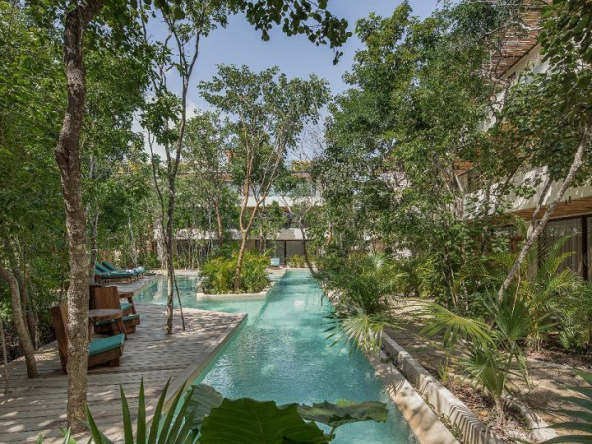 Garden pool in the shape of river at Copal Tulum