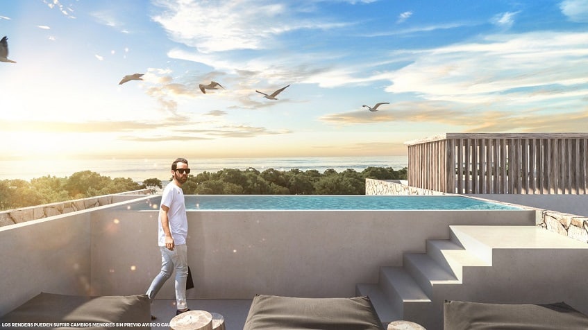 Rooftop pool with a view of the ocean and a man with sunglasses at Santamar Akumal