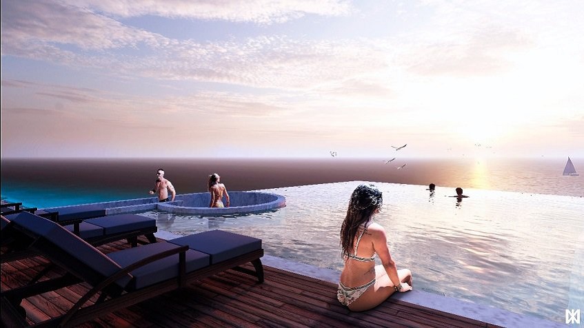 Rooftop pool and woman sitting on the sundeck and looking at the ocean at The Maria Cozumel