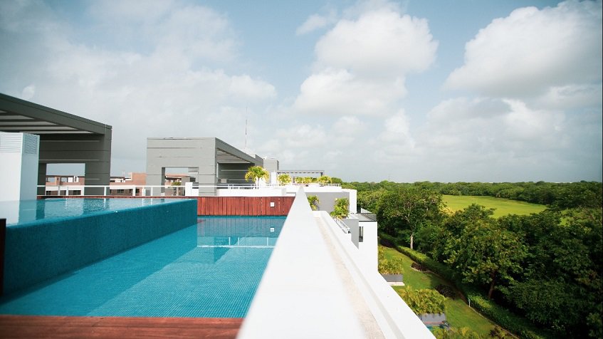 Rooftop double pool next to pergola at Nick Price Residences