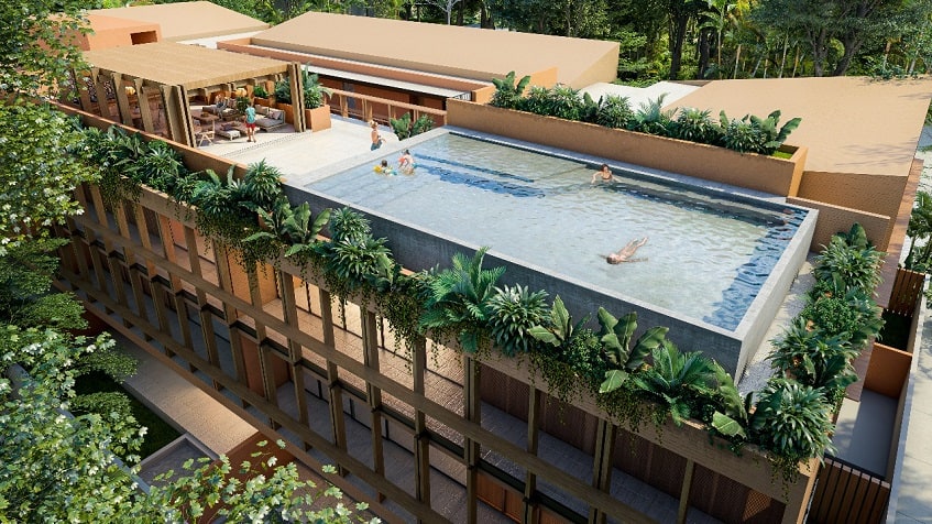 Rooftop pool and lounge area under pergola and people swimming at Kante Apartments