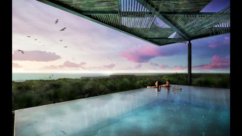 Rooftop pool with jungle view and ocean in the background Novara Elevated Living