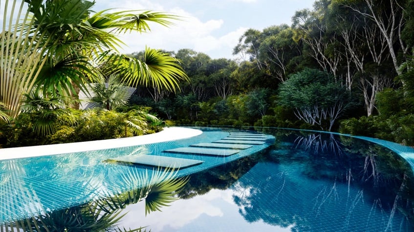 Long pool with sunbeds inside surrounded by the jungle at Taema Residential