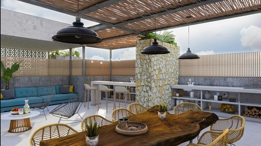 Rooftop with bbq grill, long table and sofa at Torre Tierra Urban Condos