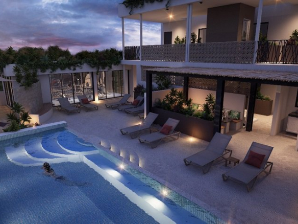 Pool area and woman swimming and other women doing yoga at night at Condo Taak