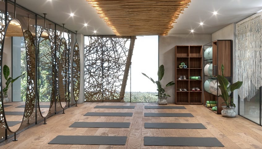 Yoga room with exercise mats in front of oval mirrors at Akua Tulum