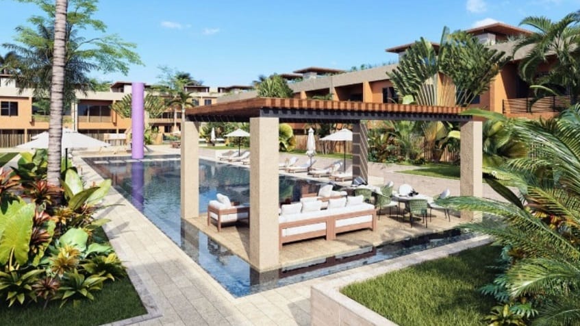 Swimming pool with white sofas on the platform under pergola in the garden at Aleda Playa