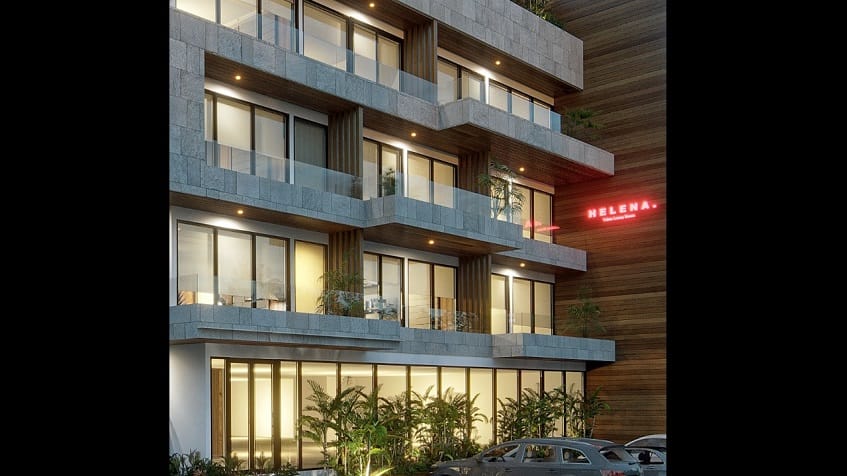 View of the residential building facade with balconies and tall windows at Helena Tulum Luxury Homes