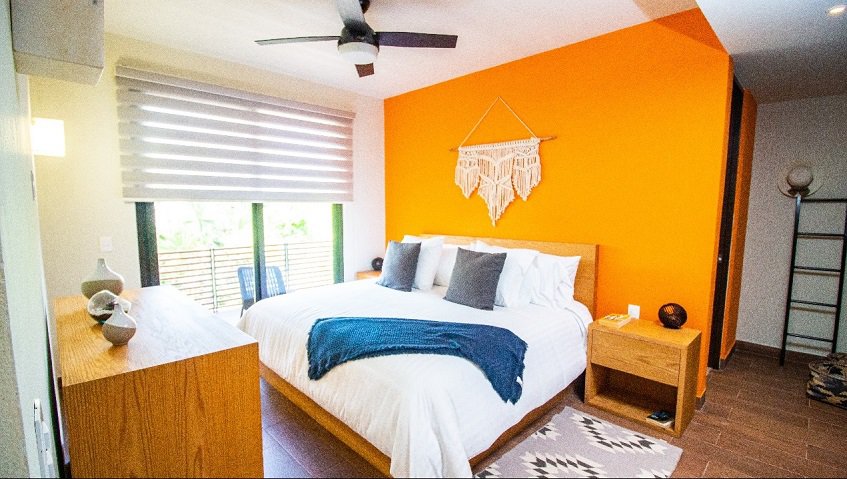 Bedroom with a bed by the tall window and terrace at Aleda Playa