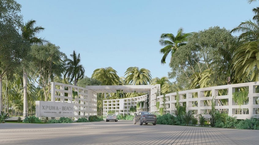 Main gate and white rectangle construction and two cars passing at Xpu-Ha Beach Residential Resort