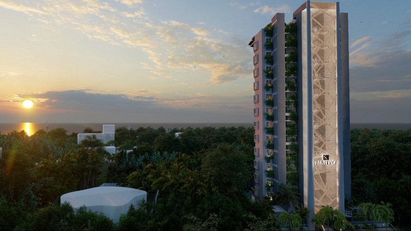 Tall residential building facade with sunset view over the ocean at Nativo Cozumel