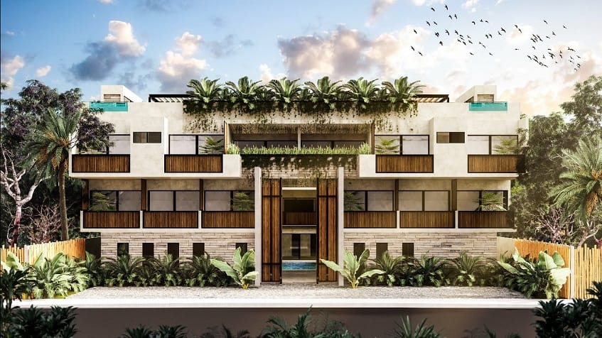 Four level residential building facade surrounded by vegetation at Irie Tulum