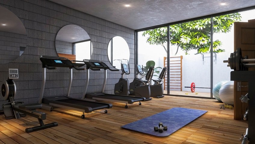 Gym room with treadmills and weights at Torre Tierra Urban Condos