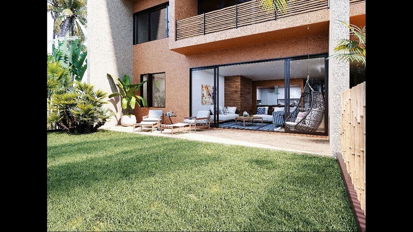 Green backyard and terrace of an orange house at Aleda Playa