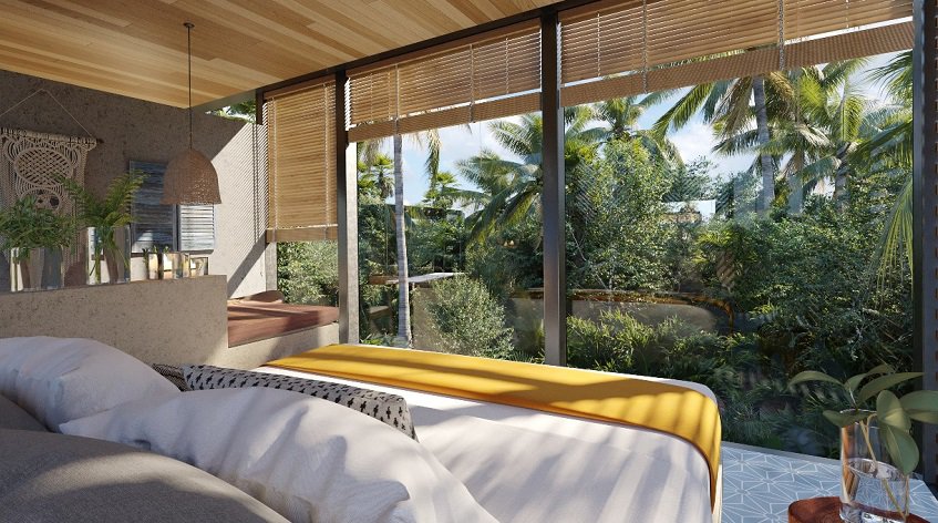 Bedroom with king size bed in front of glass windows at Chay Reflection Lofts Tulum