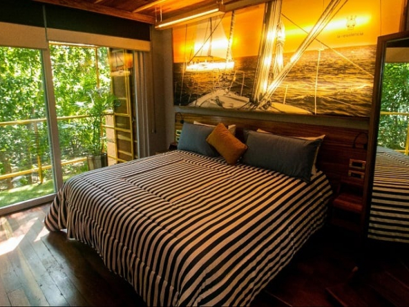 Bedroom with two double bed by the tall window at Residencia Condos