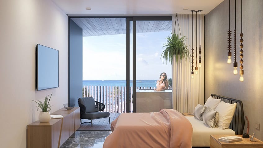 Ocean view bedroom and woman on the terrace at IT Beach