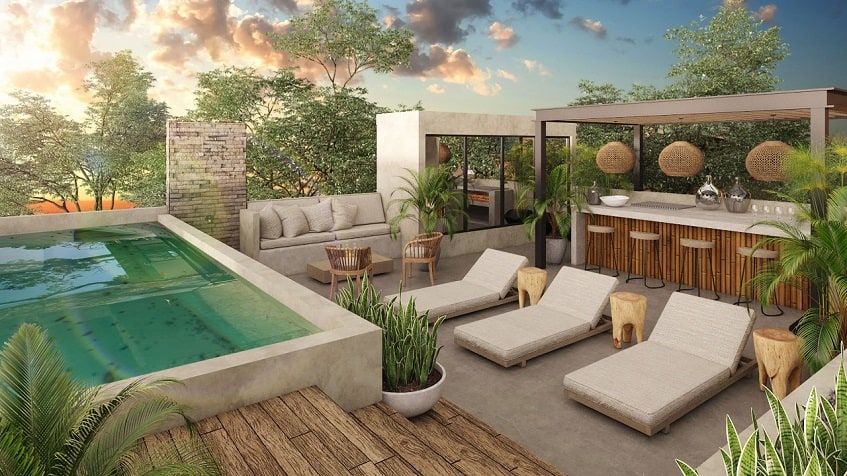 Rooftop swimming pool and sundeck by the bar area at Irie Tulum
