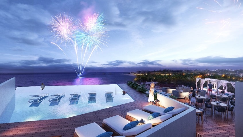 Rooftop swimming pool and woman watching fireworks at IT Beach