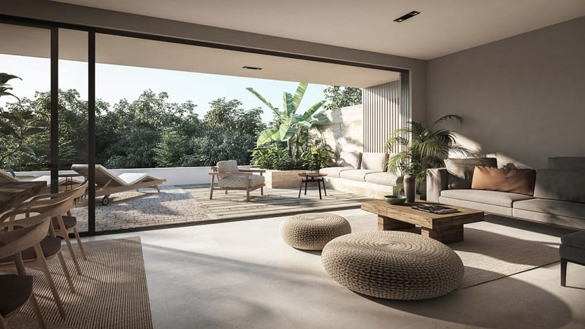 Terrace and living room with a glass window between at Reserve at Mayakoba