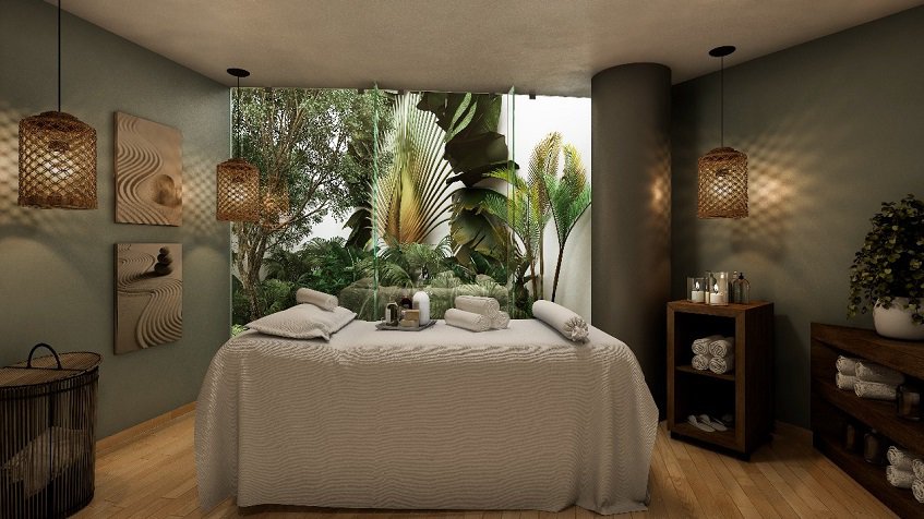 Spa room with massage bed with a view of the garden at Marila