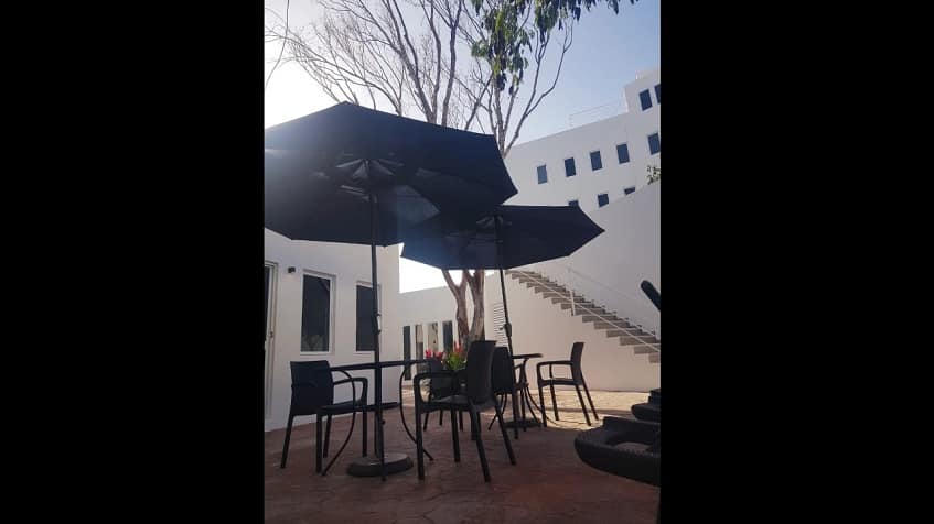 White residential building and garden table with umbrella at StarLight Towers
