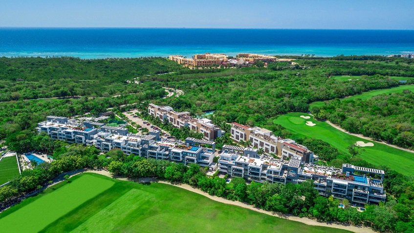 View of residential complex surrounded by golf course and ocean at Nick Price Residences