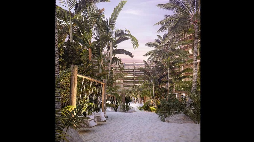Beach with two swings surrounded by vegetation by the Costa Residences & Beach Club