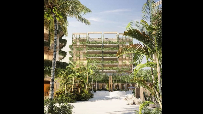 Building with green balconies at the end of beach walk way at Costa Residences & Beach Club