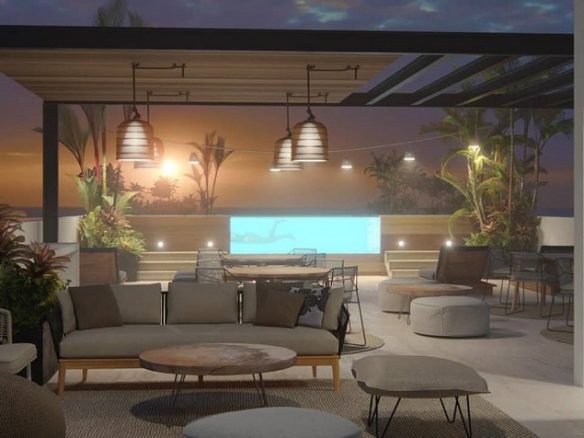 Night time view of lounge area and swimming pool in the rooftop at Distrito Morelos