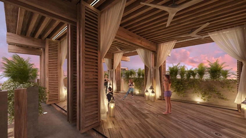Wooden deck inside open space room with women doing yoga at Alquimia Home Resort