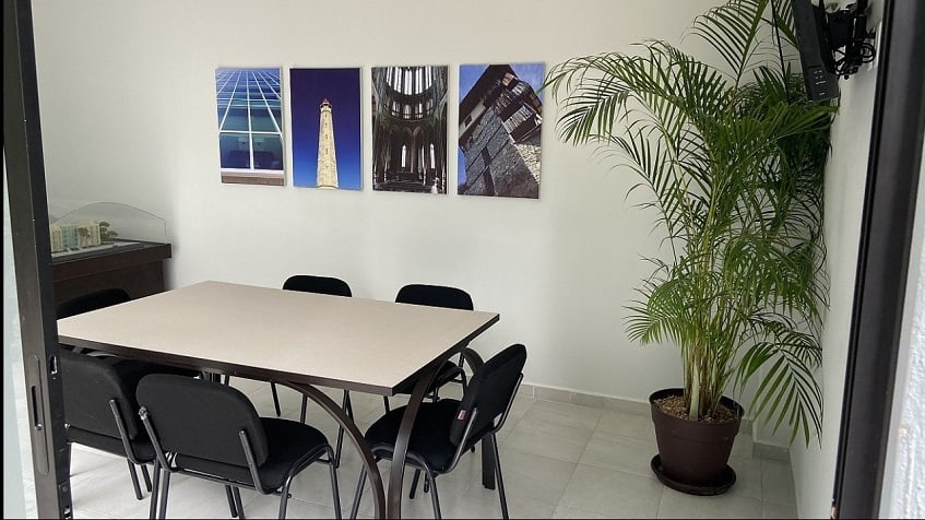 Room with a table and chairs, pictures of architectural statues at Riviera Towers 2
