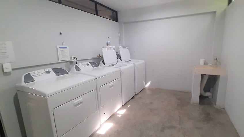 Laundry area with washing machines at Riviera Towers 2