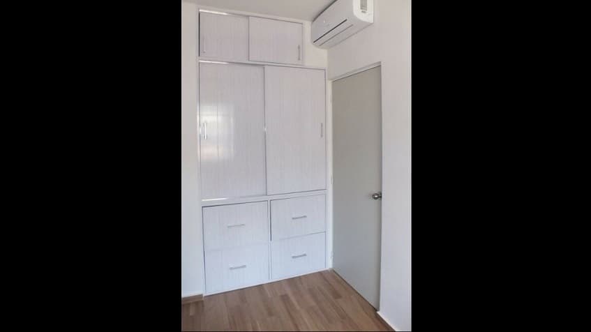 Room with white build in closet at Alcala Condos