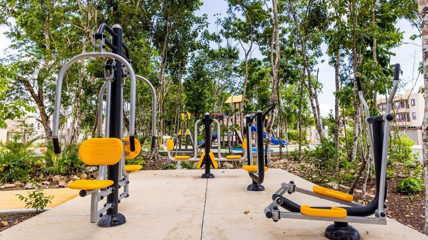 Open air gym surrounded by trees at Alcala Condos
