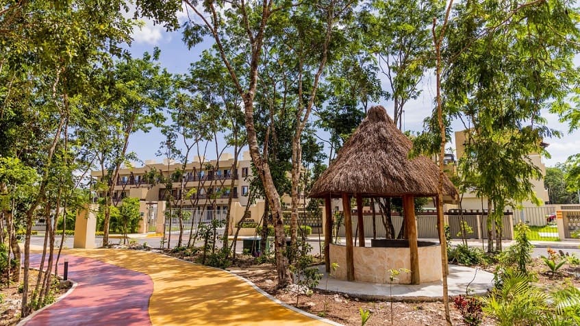 Park with small palapa and residential condominium in the background at Alcala Condos