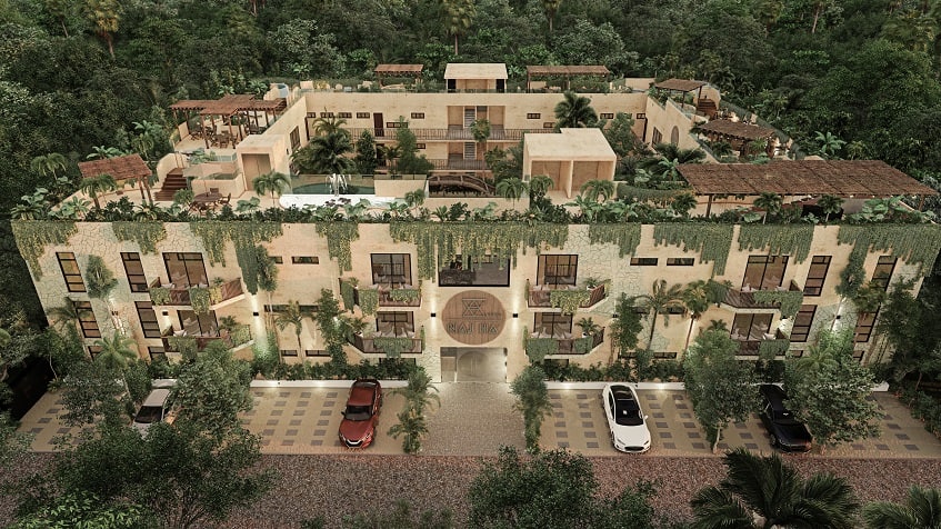 Residential building facade in a square shape and parking lot at Elemental Tulum