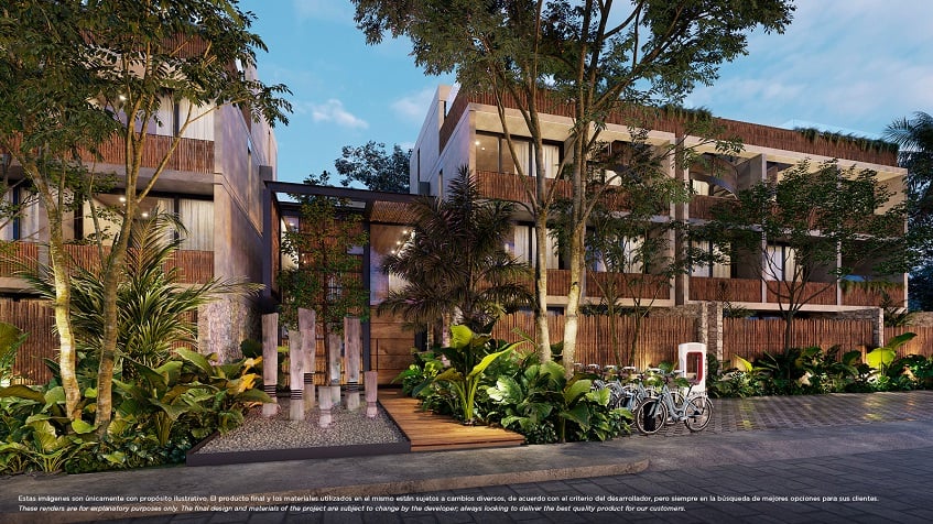 Residential building facade and bicycle parking surrounded by vegetation at Nativa Tulum