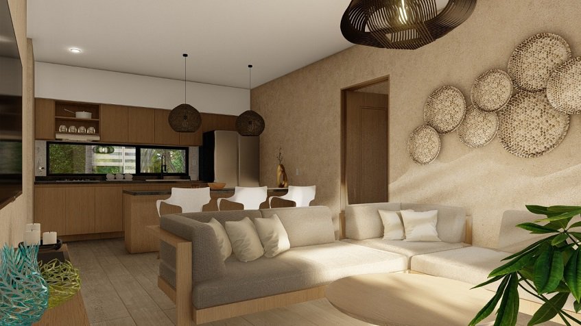 Living room with circle decoration over the sofa and kitchen at Elemental Tulum