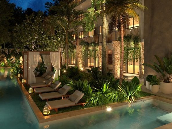 Garden with a pool and sunbeds during night time at Akua Reserve