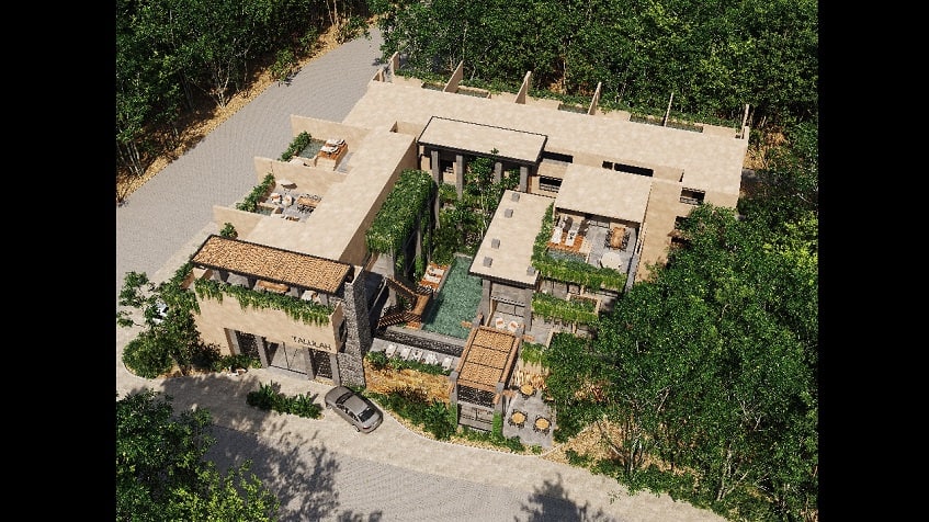 Top view of a residential building with a pool in the middle surrounded by vegetation at Talulah Tulum