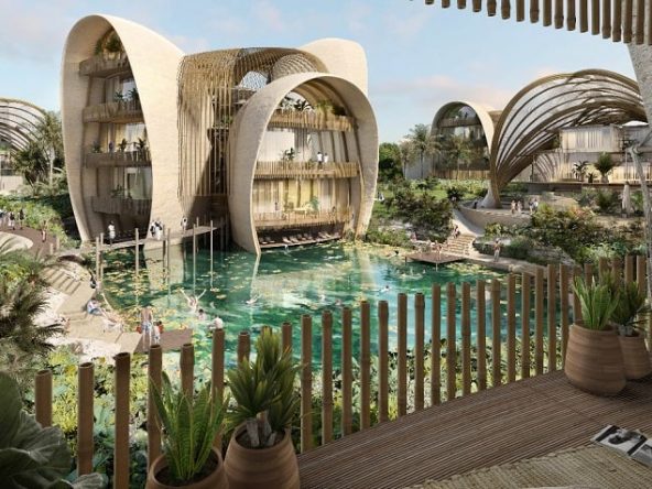 View of a residential area with houses separated with water and woman on the balcony at Mondo Tulum