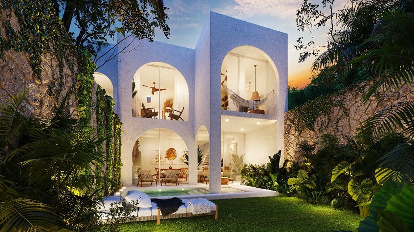 White residential building facade with a garden pool surrounded by vegetation at Domum Tulum